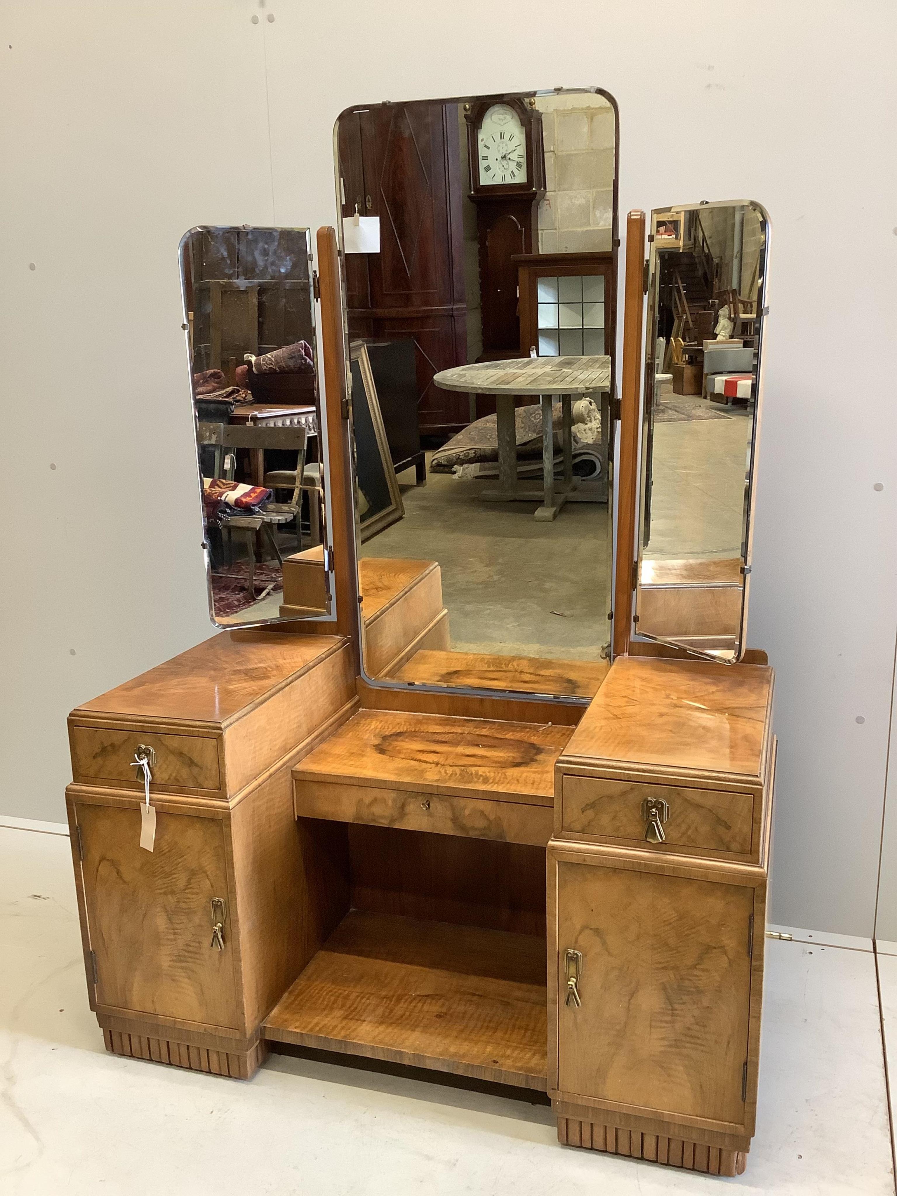 An Art Deco walnut dressing table, width 107cm, height 154cm. Condition - fair to good